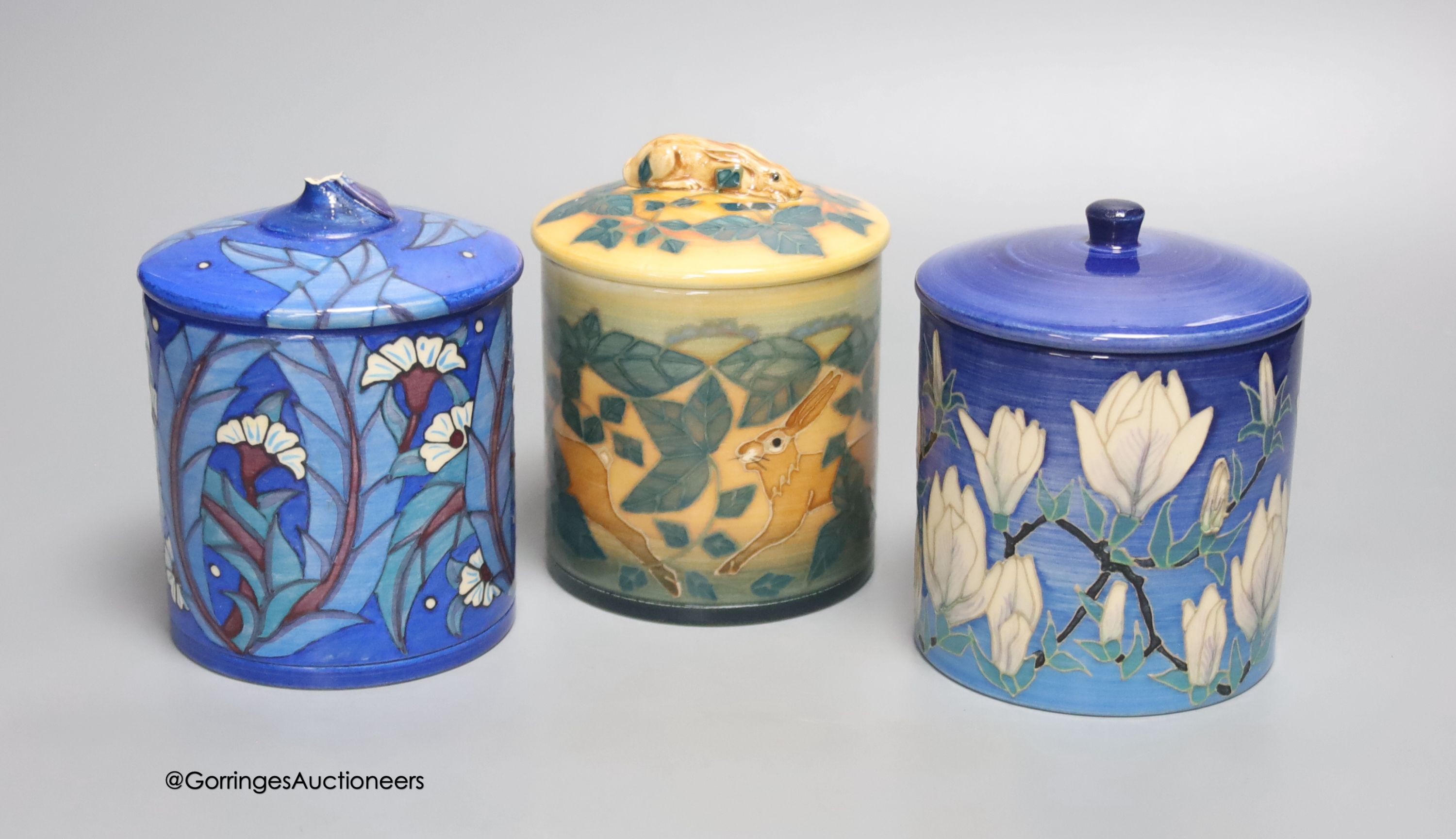 Sally Tuffin for Dennis China Works: a jar decorated with hares, a jar decorated with magnolia blooms and a pot and cover, tallest 11.5cm